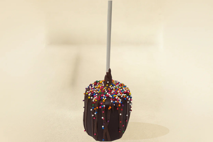 Dark chocolate marshmallow pop with milk drizzle and sprinkles