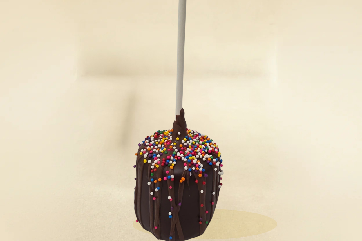 Dark Chocolate marshmallow pop with milk drizzle and sprinkles