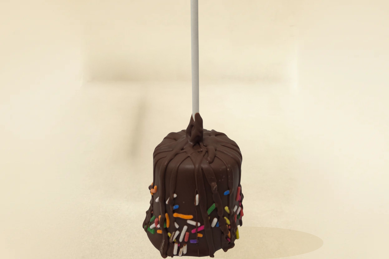 Milk Chocolate marshmallow pop with milk drizzle and jimmies