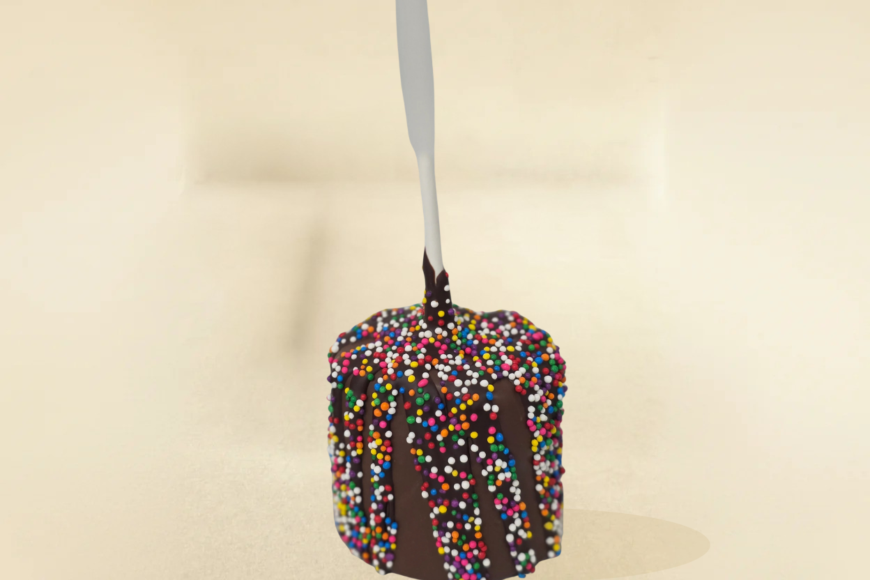 milk chocolate marshmallow pop with milk drizzle and sprinkles