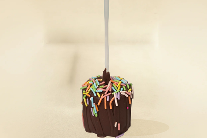 milk chocolate marshmallow pop with milk drizzle and jimmies