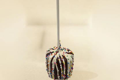 Milk chocolate marshmallow pop with white drizzle and sprinkles