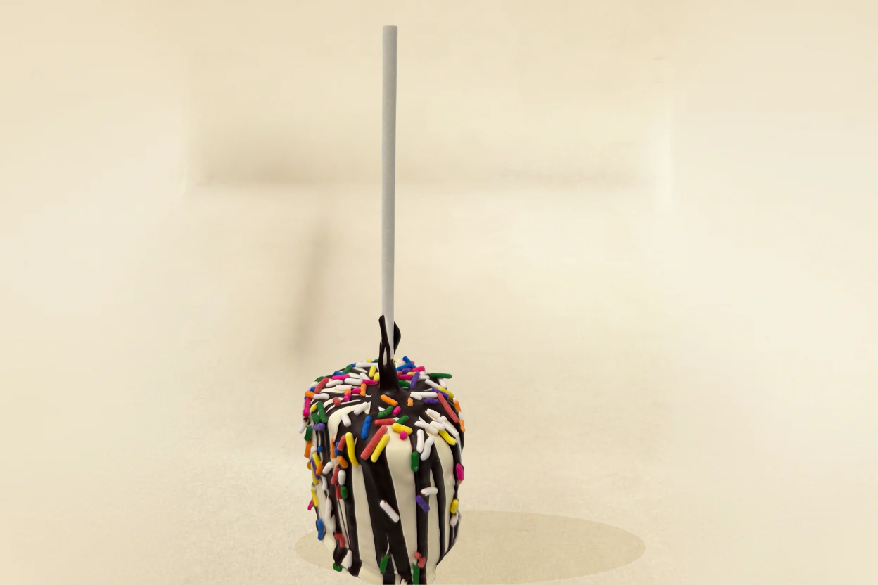 White Chocolate marshmallow pop with dark drizzle and jimmies