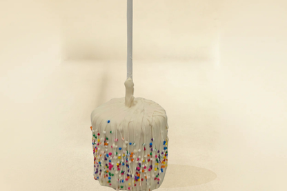 white chocolate marshmallow pop with white drizzle and sprinkles