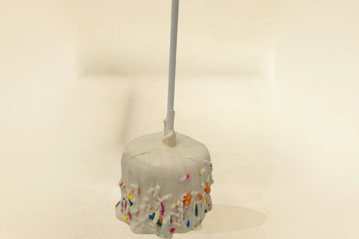white chocolate marshmallow pop with white drizzle and jimmies