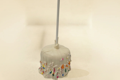 white chocolate marshmallow pop with white drizzle and jimmies