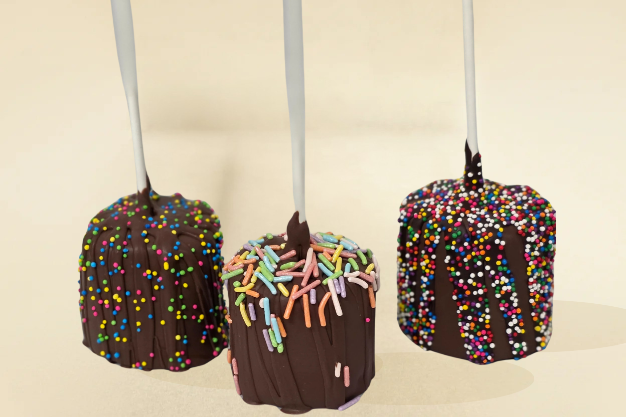 Milk chocolate marshmallows with milk drizzle and sprinkles