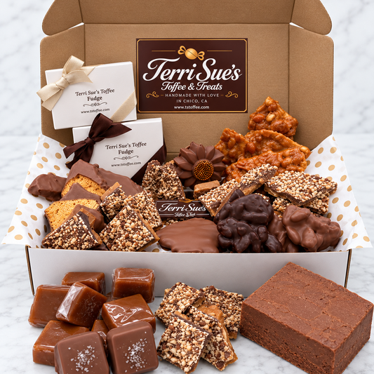 An open cardboard gift box filled with assorted chocolate treats and sweets, arranged on white tissue paper with brown polka dots. Visible products include chocolate-dipped cookies, chocolate-covered pieces, caramel squares, and boxed chocolates.